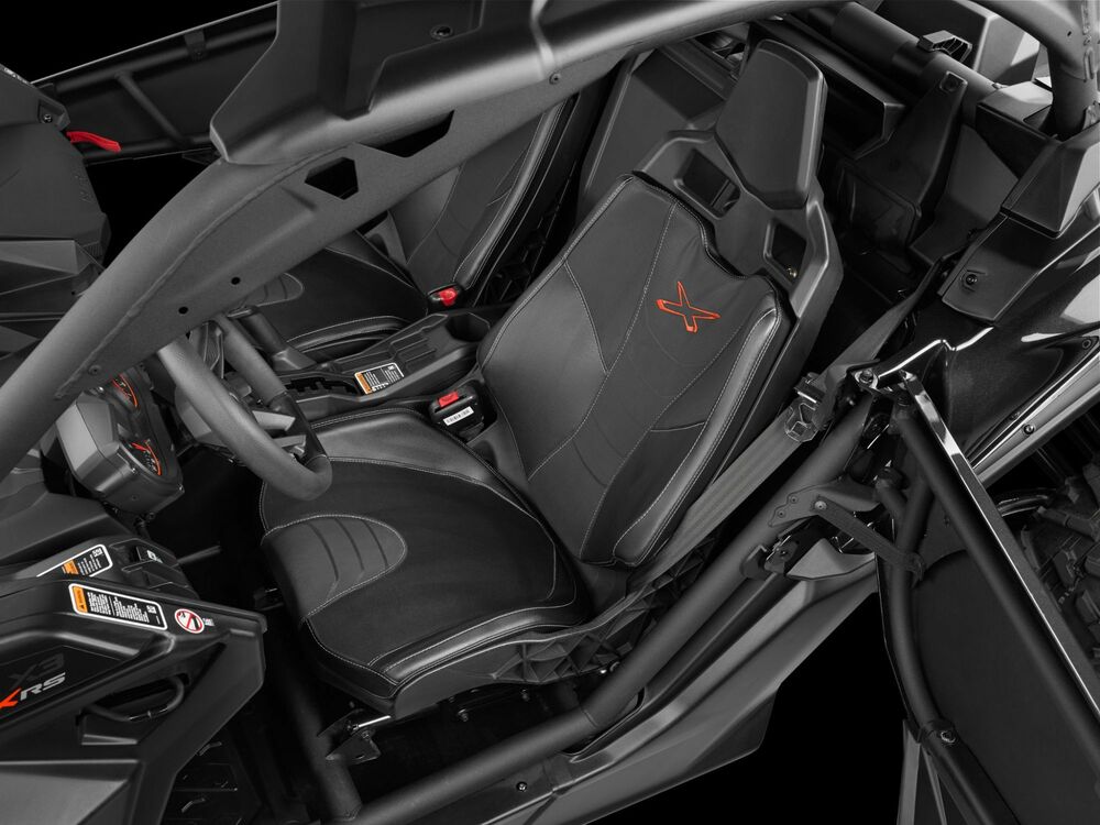 Black interior car seats with orange embroidered logos, shown inside a roll cage vehicle cabin.