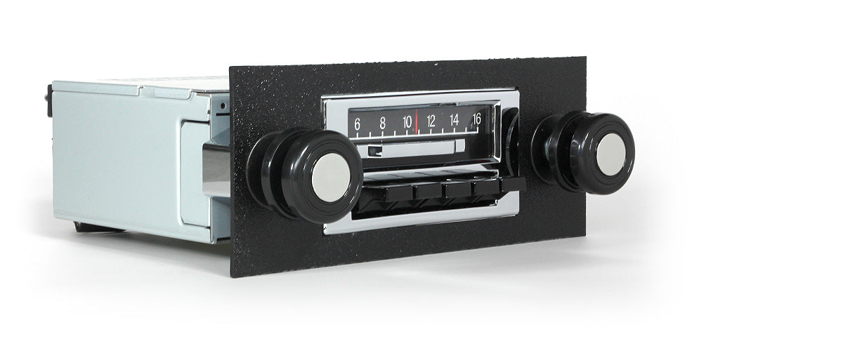 Vintage car radio with black casing and white face on a white background