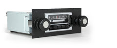 Vintage car radio with black casing and white face on a white background