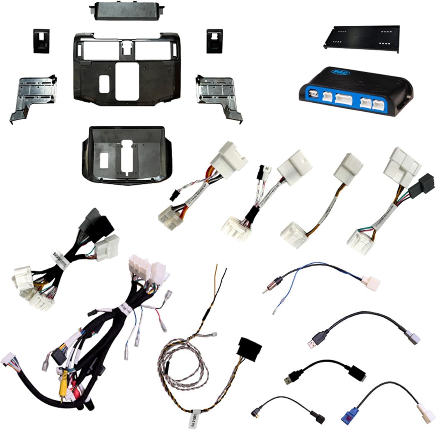 Collection of car stereo components including wiring harnesses and panels on a white background