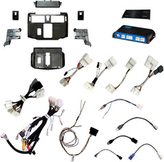 Collection of car stereo components including wiring harnesses and panels on a white background