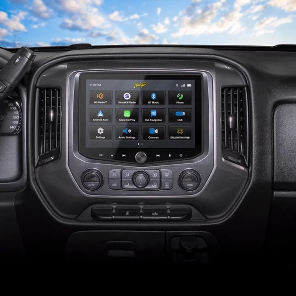 Car dashboard with a touchscreen display against a blue sky with clouds