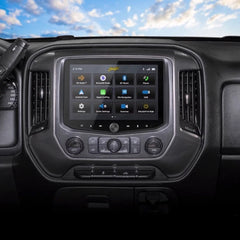 Car dashboard with a touchscreen display against a blue sky with clouds