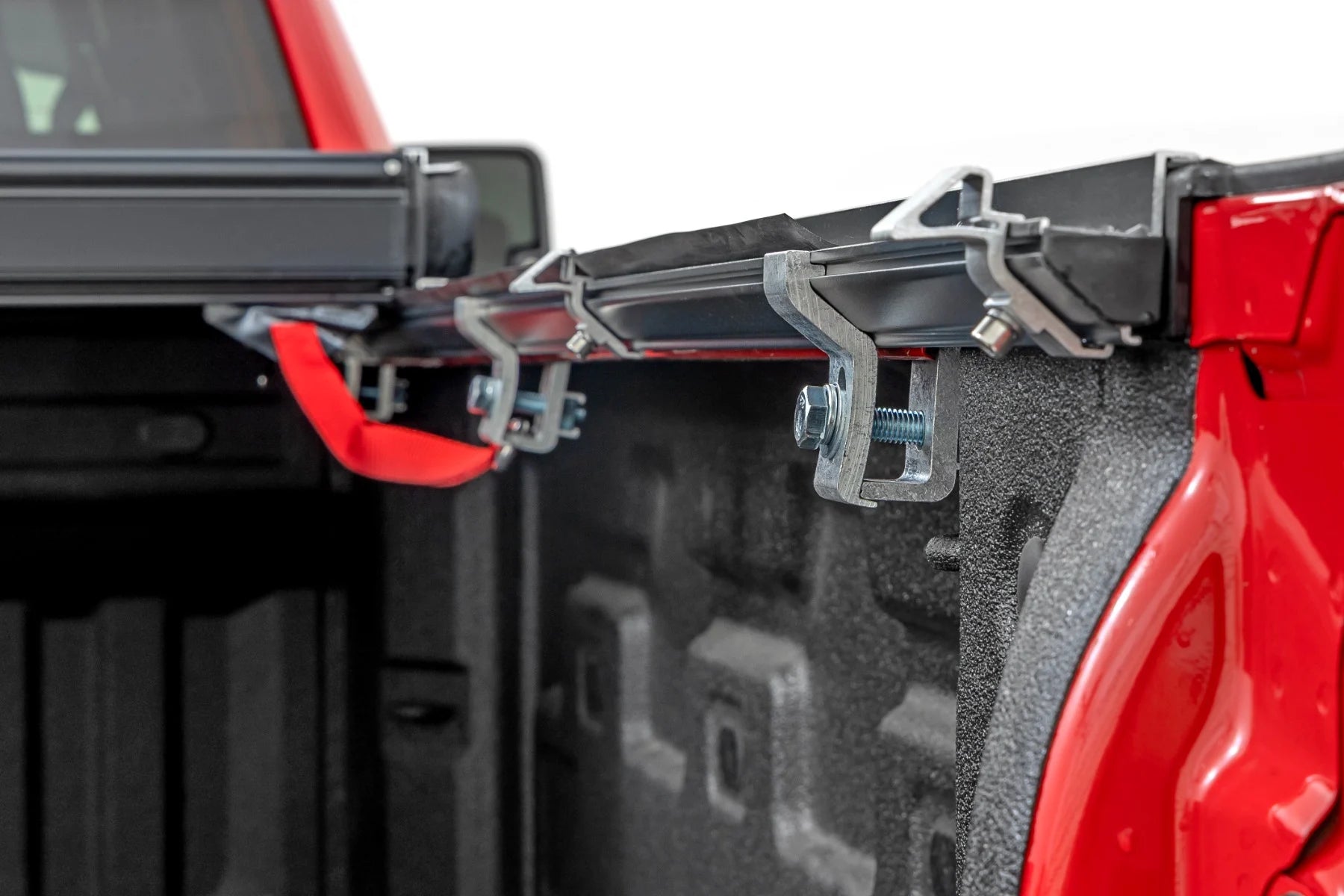 Close-up of a truck bed rack system on a red truck