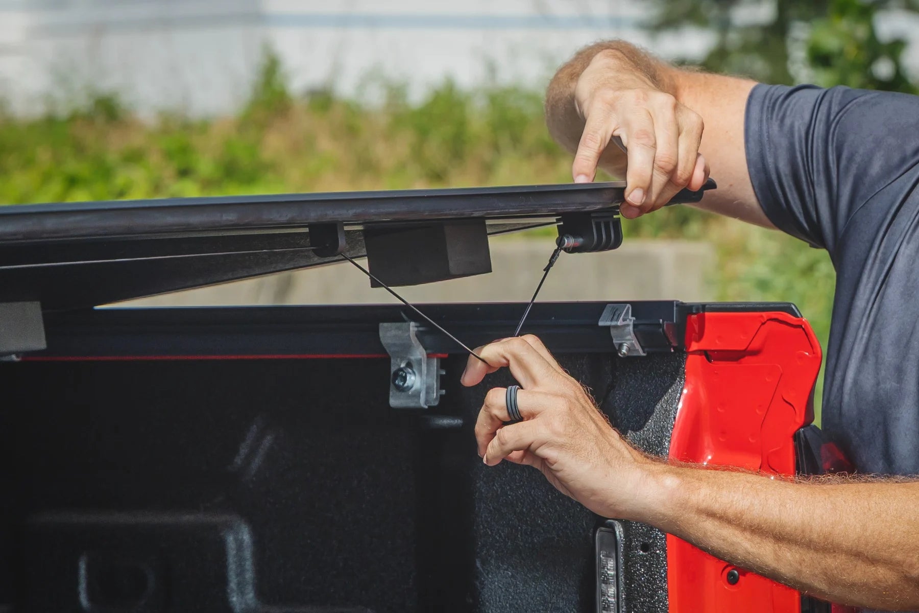 Person installing a roof rack on a vehicle