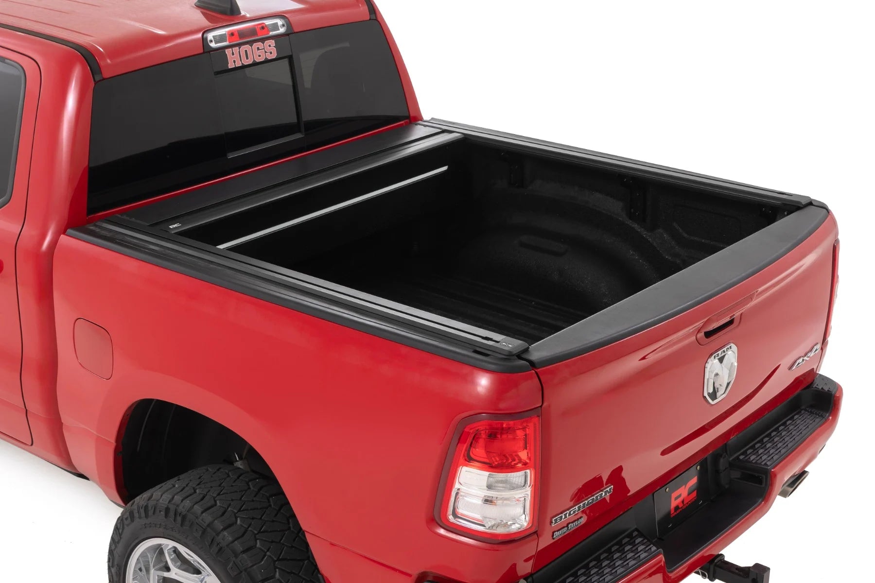 Red truck with a black tonneau cover on a white background
