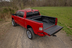 Red pickup truck with an open bed on a dirt road