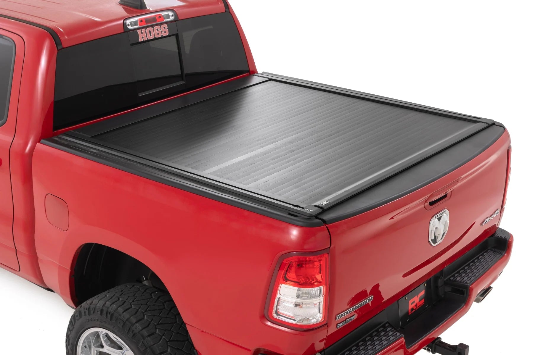 Red truck with a black tonneau cover on a white background