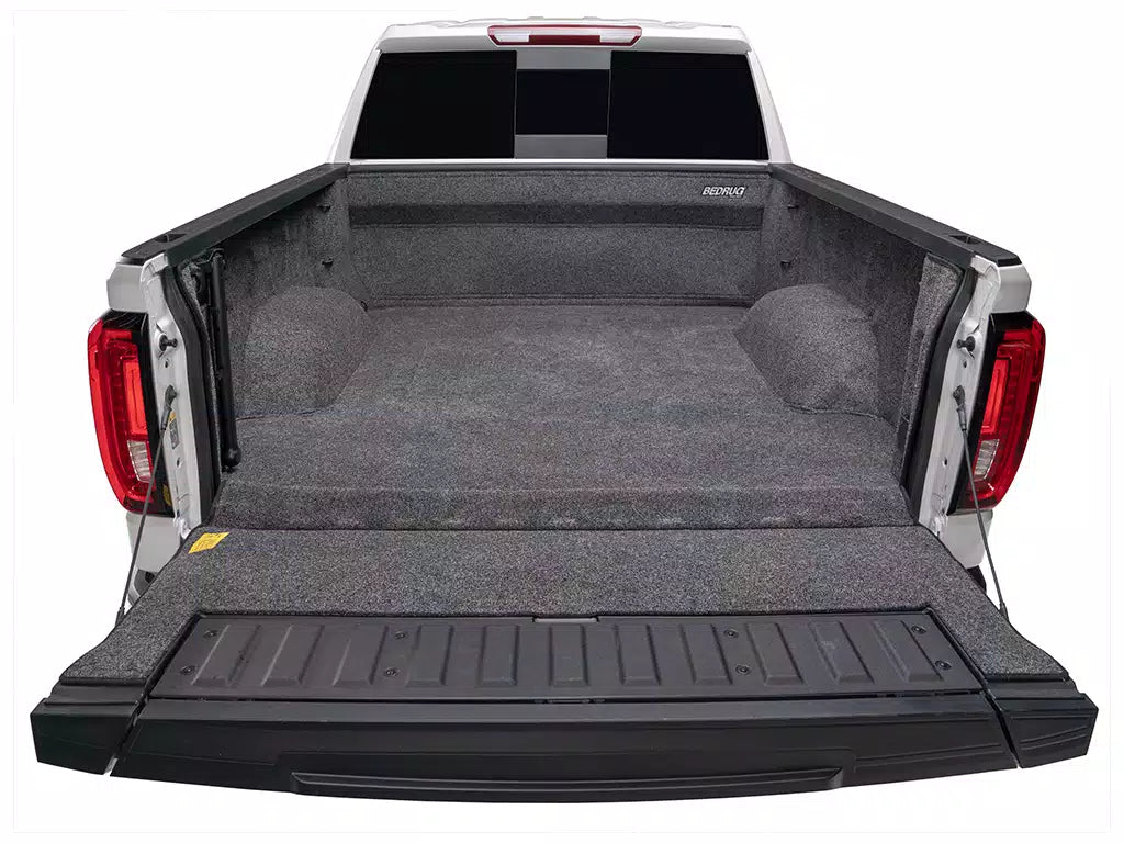 Truck bed with a black cargo bed liner on a white background