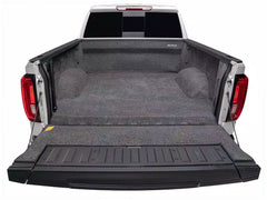 Truck bed with a black cargo bed liner on a white background