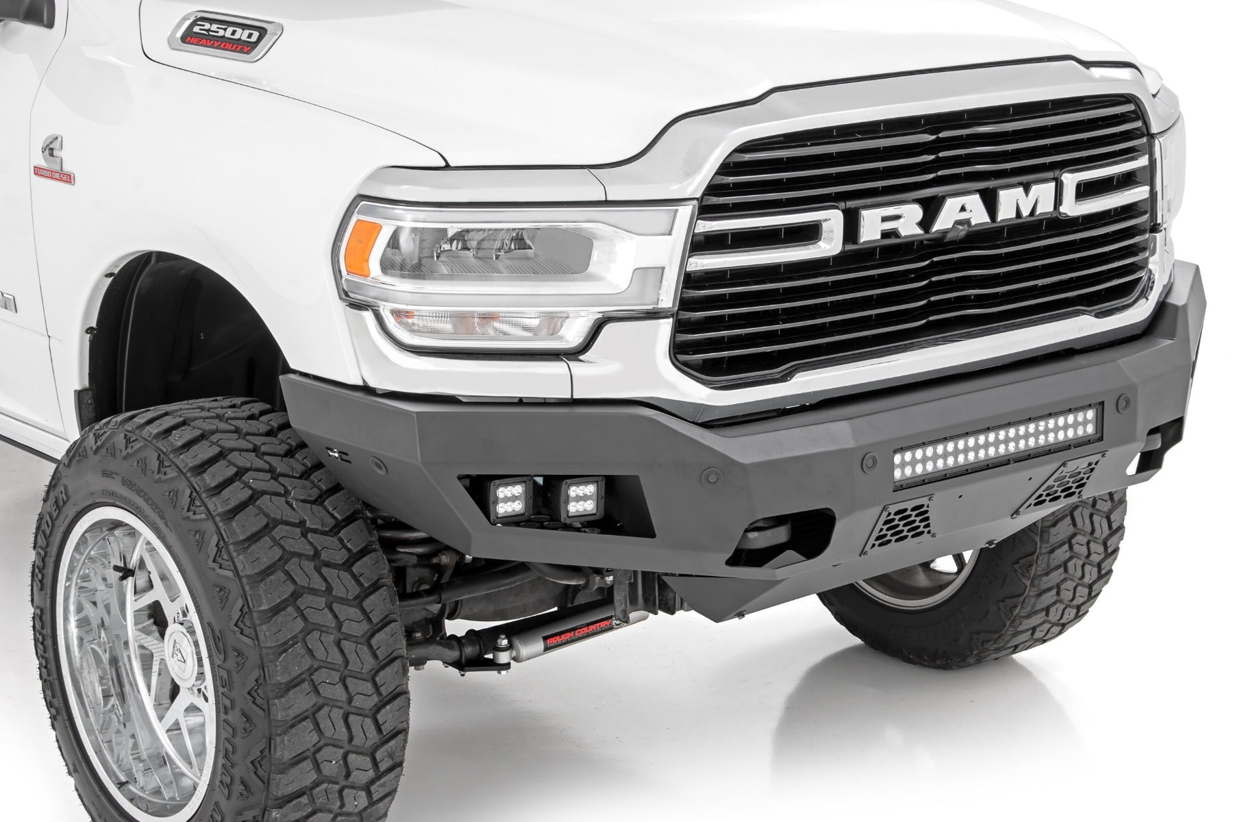 Front view of a white Ram truck with off-road bumper on a white background