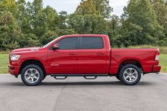 Red Ram truck parked on a paved road with trees in the background