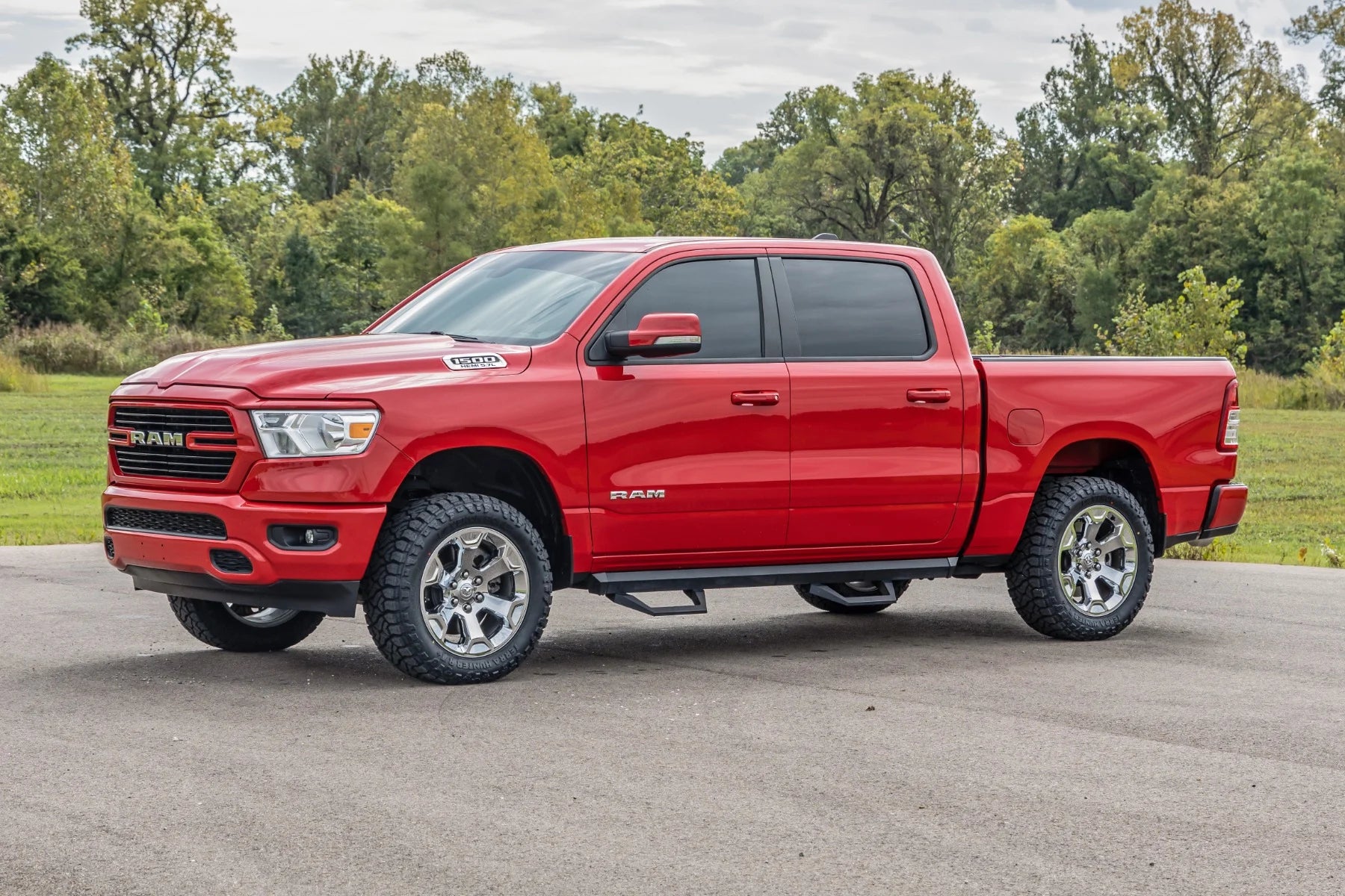 Red Ram truck parked on a road with trees in the background