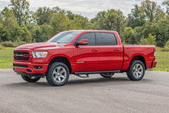 Red Ram truck parked on a road with trees in the background
