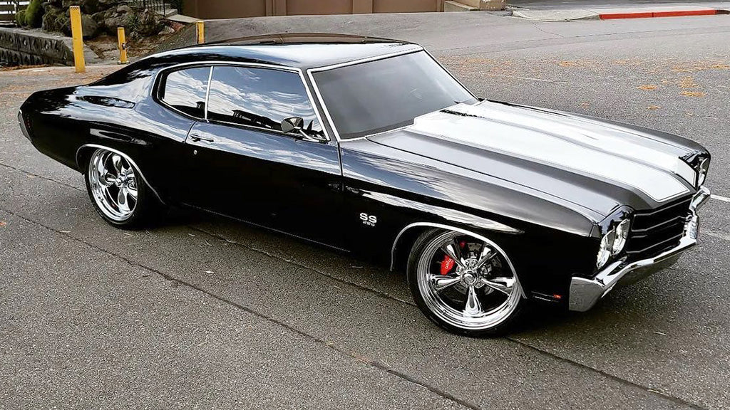 Black classic muscle car parked on a street