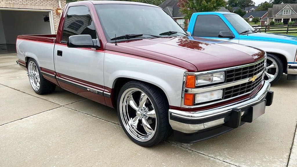 Chevy truck with a white and red color scheme parked on a driveway.