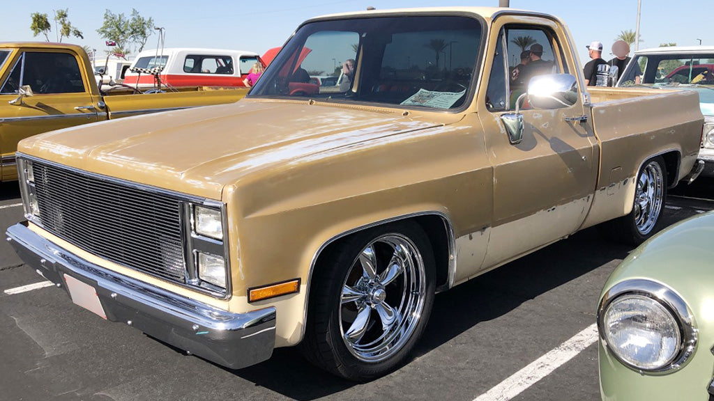 Gold pickup truck with chrome details on a parking lot